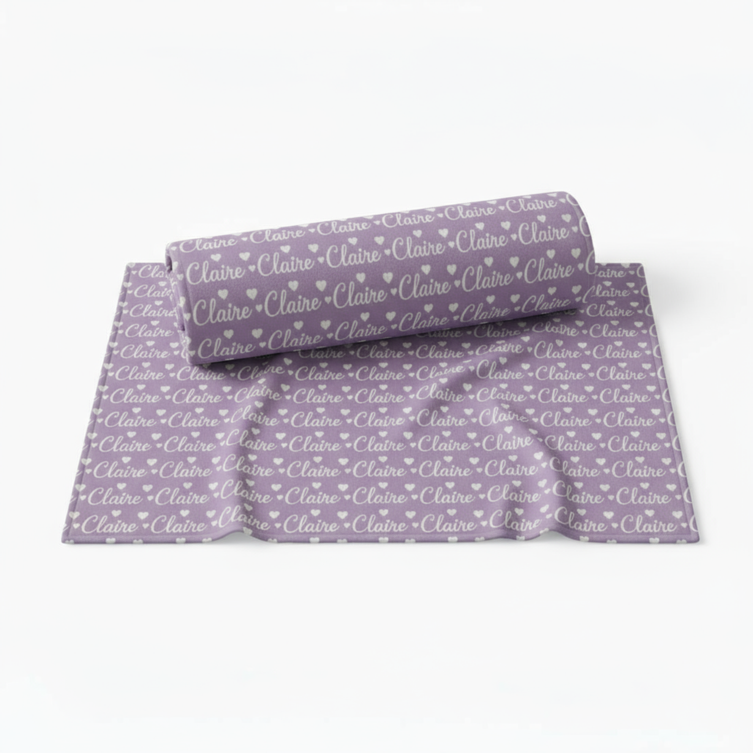 Folded purple fabric with 'Claire' printed repeatedly on a white background