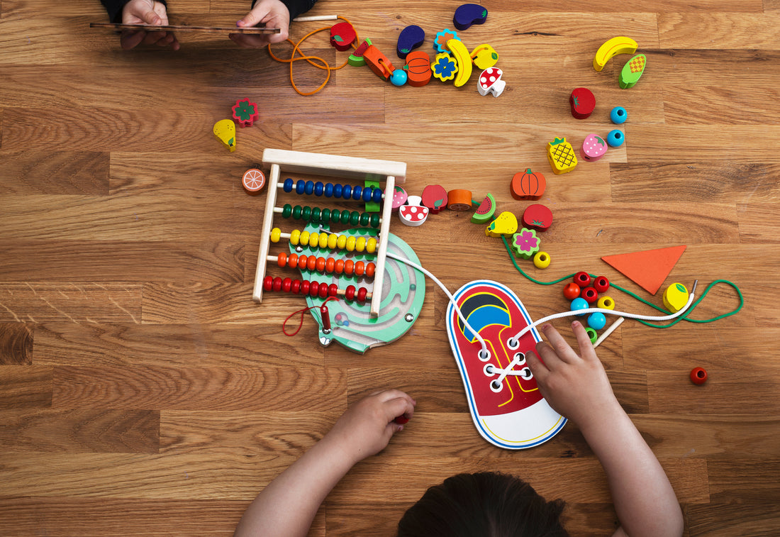A kid playing with wooden toys in a Montessori environment at home