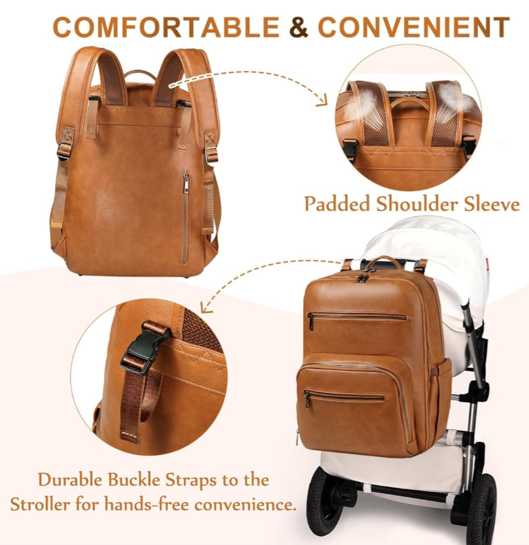 Brown faux leather diaper bag backpack hung on a stroller and showing the features