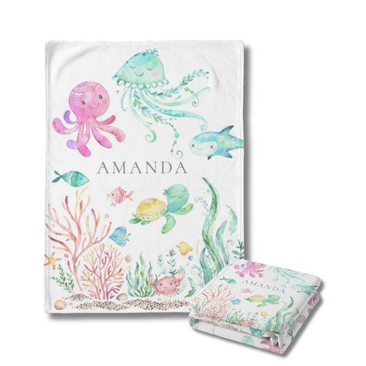Children's personalized Baby Blanket with underwater-themed illustrations and a matching blanket on a white background