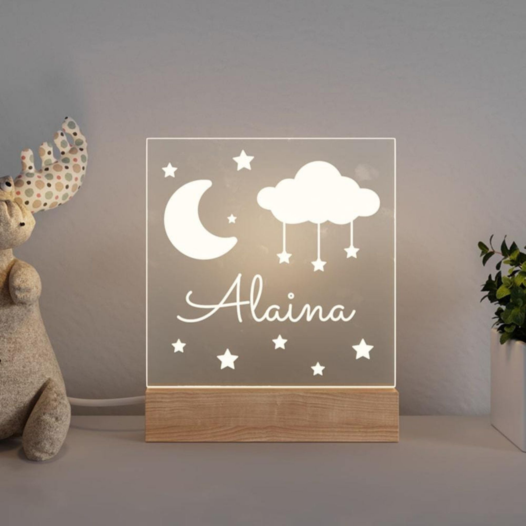 Personalized rocket night light glowing baby's name during bedtime story
