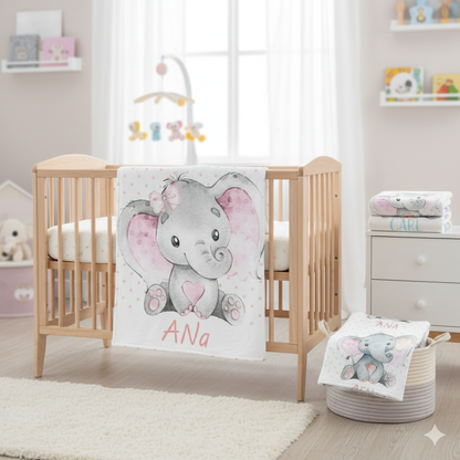 Nursery room with a crib, baby blanket with an elephant design, and a basket with more items.