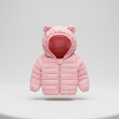 A light pink puffer jacket for toddlers, featuring a hood with decorative bear ears and a front zipper, shown against a neutral light gray background.