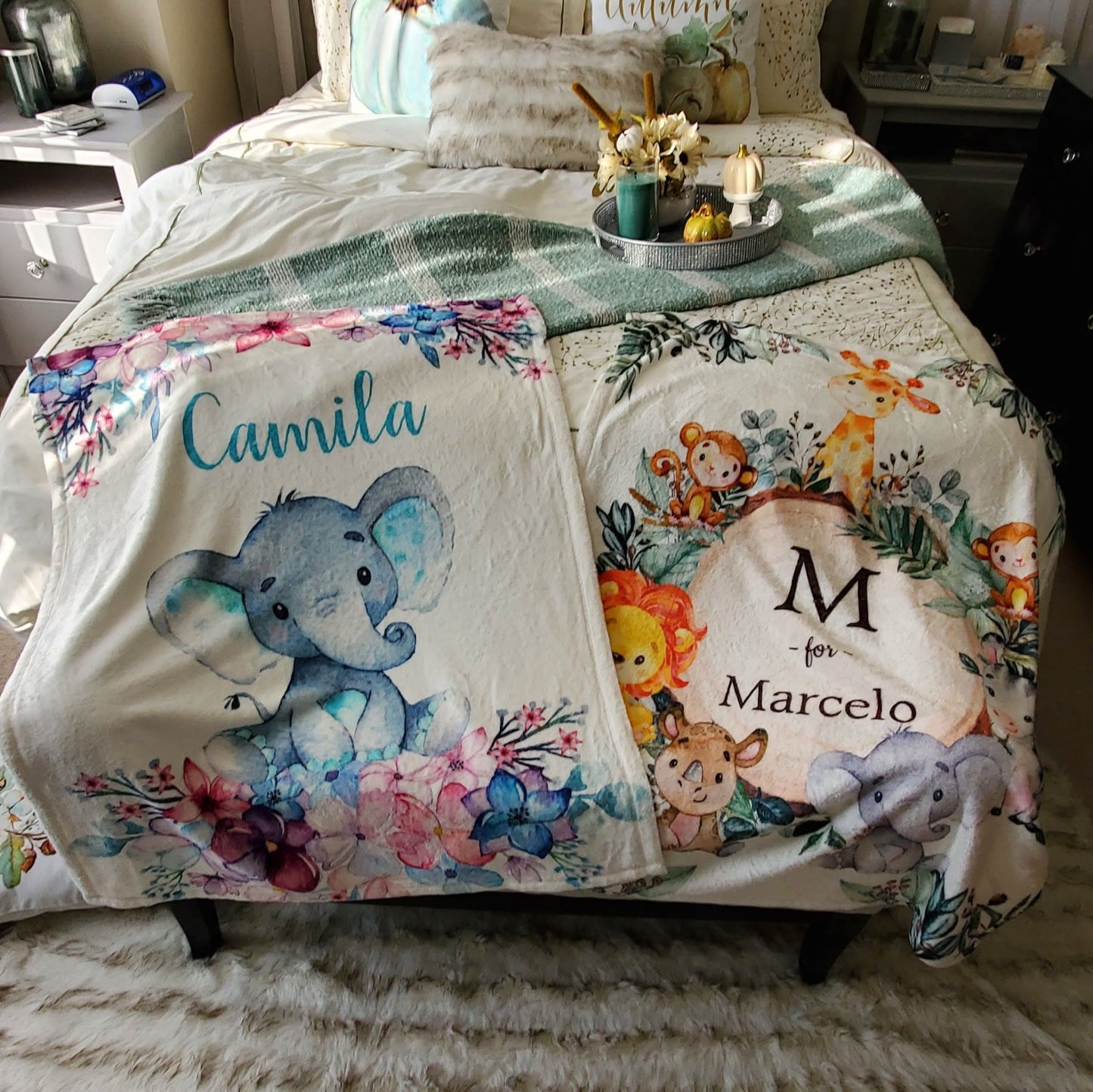 two personalized baby fleece blankets with the baby's name on the bed in a bedroom 