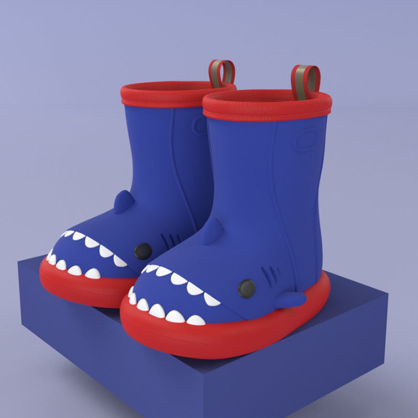 pair of blue shark rain boots with red soles on a blue block for display