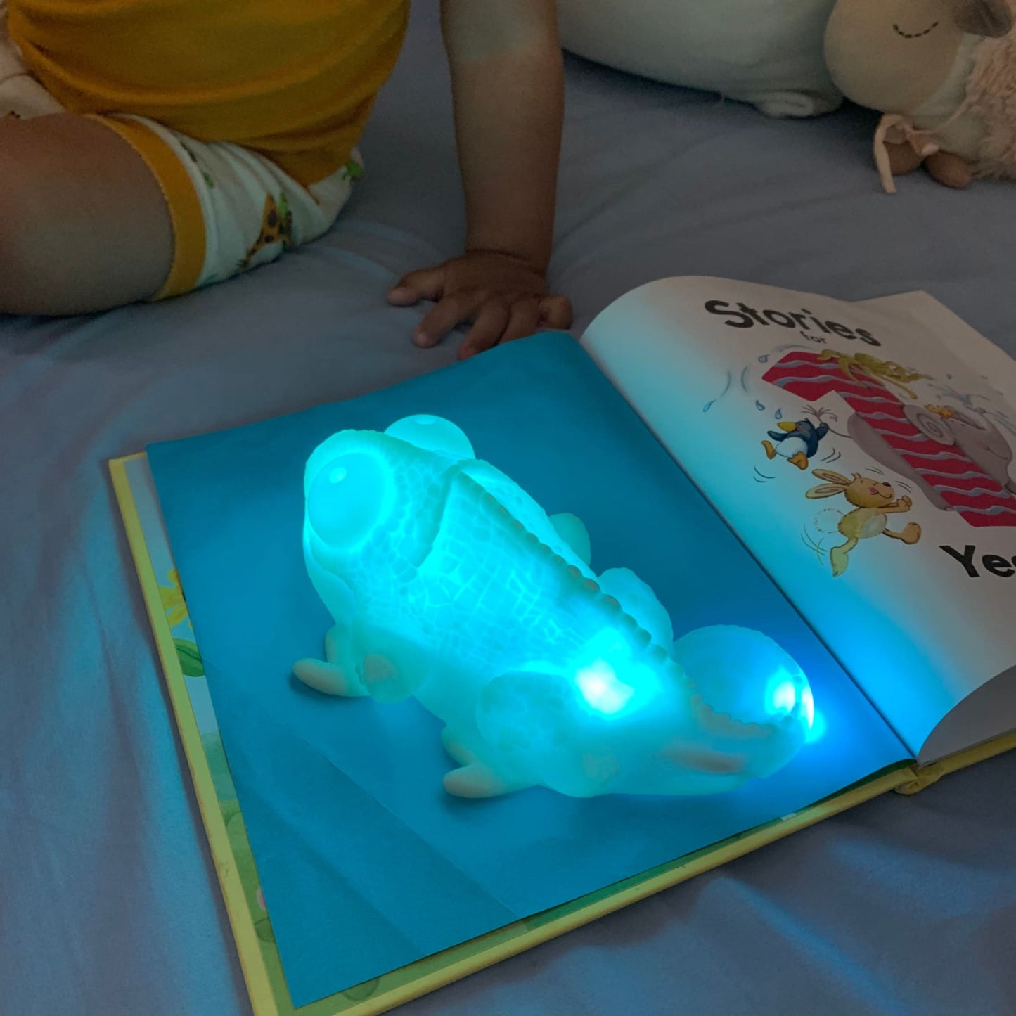 colour chbaging chameleon lamp placed on a blue paper and the lamp copied the same colour as the baby watches - hunny bubba kids