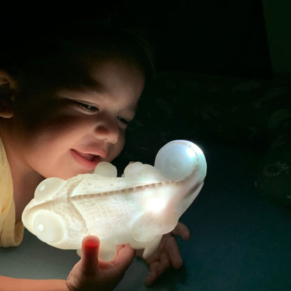 Baby playing with his night lamp in his room in the dark - Hunny Bubba Kids