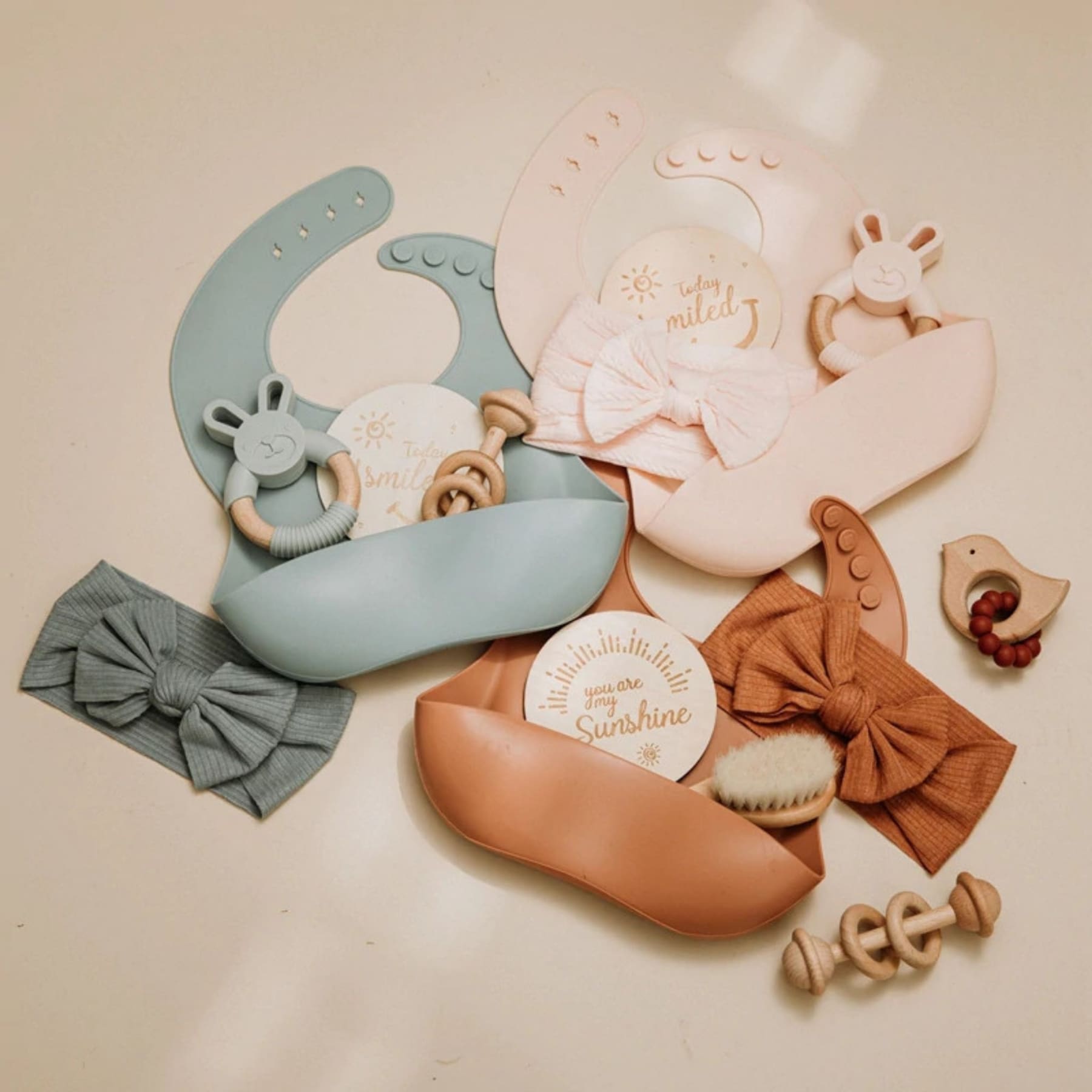 three sets of newborn baby girl with ribbons, rattle and silicone bibs | Hunny Bubba Kids