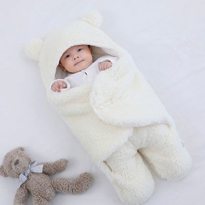 baby in polar white baby sleeping bag and swaddle for winter - hunny bubba kids