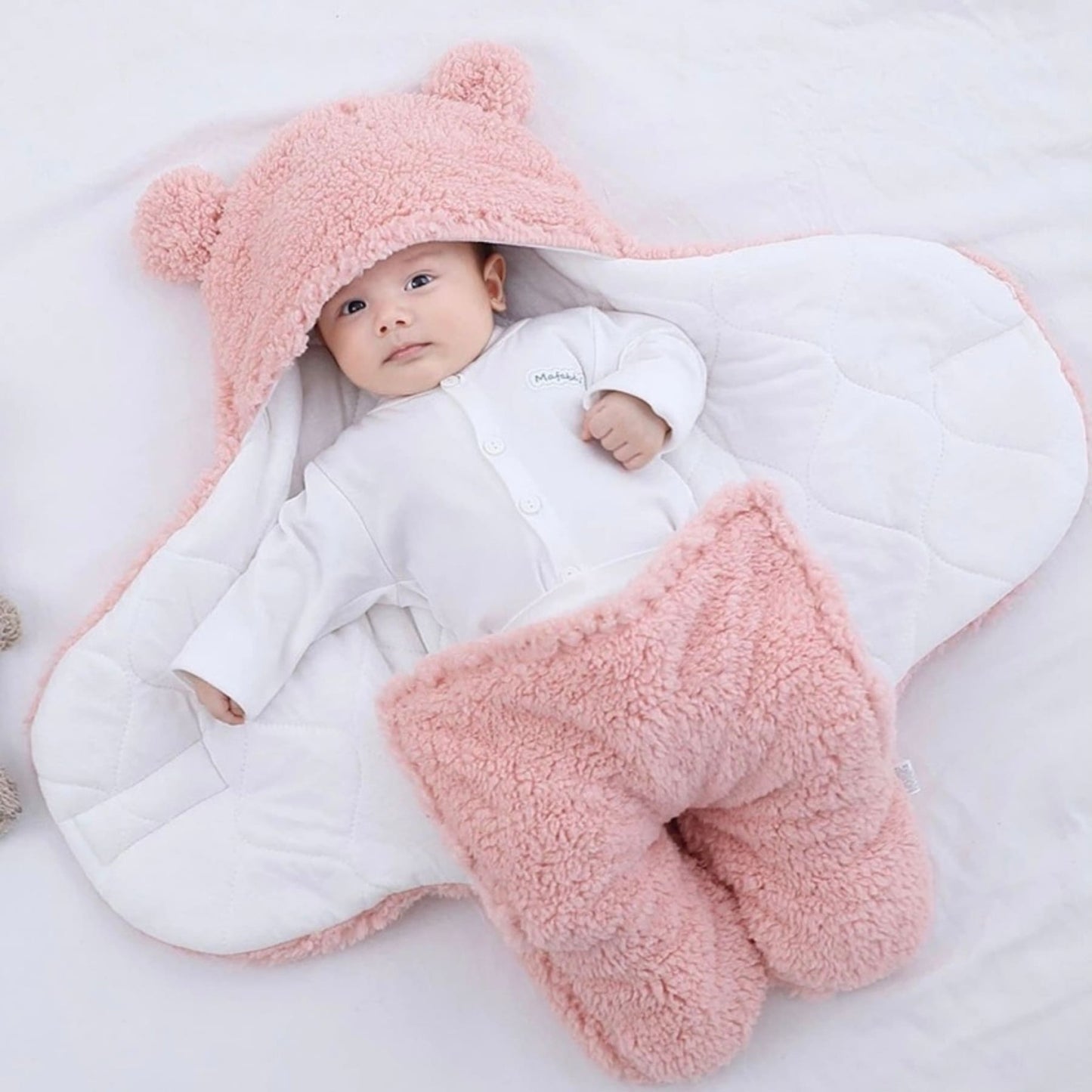 Baby in pink baby sleeping bag and swaddle for winter - hunny bubba kids