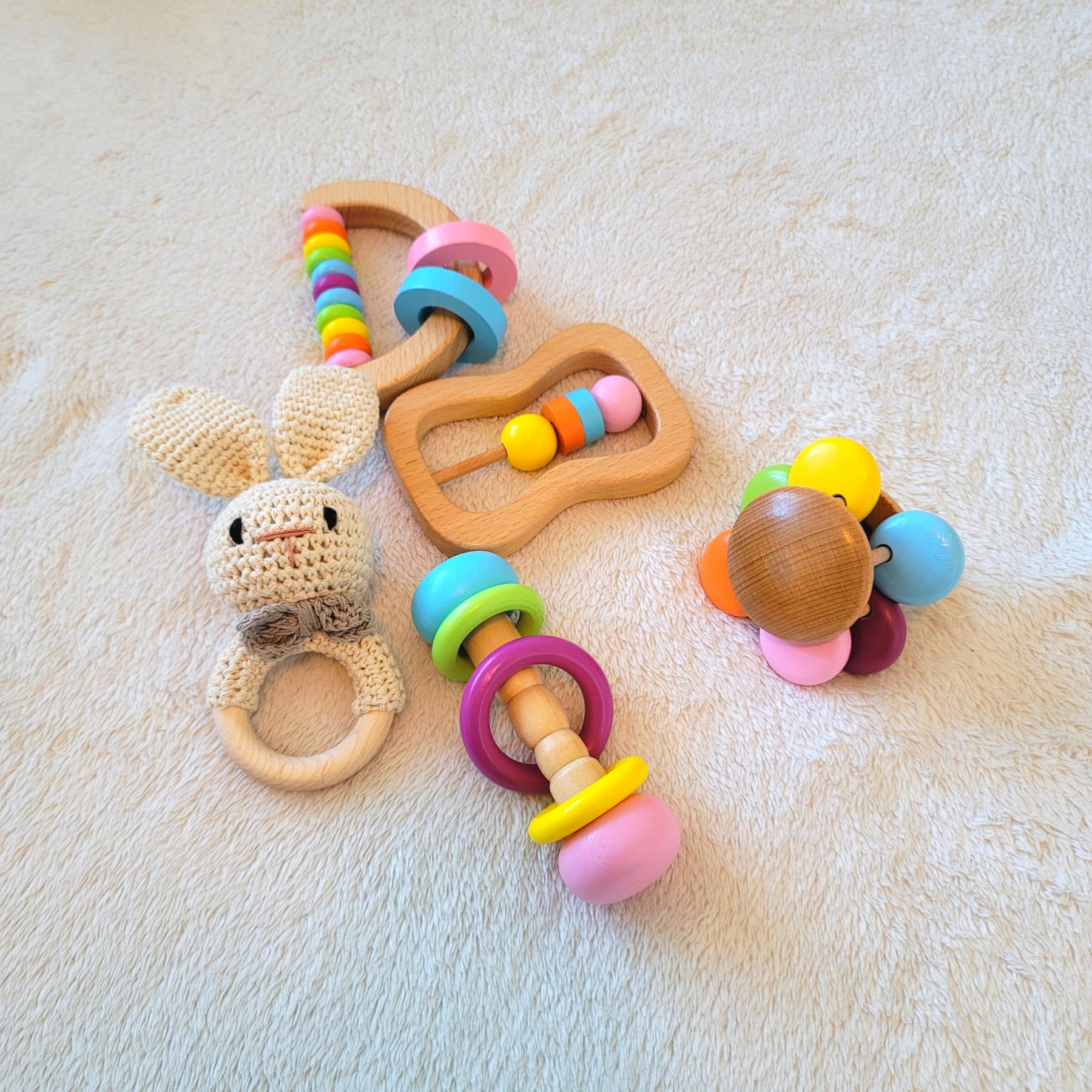 Bunny wooden montessori baby toy set on the floor with vibrant colours